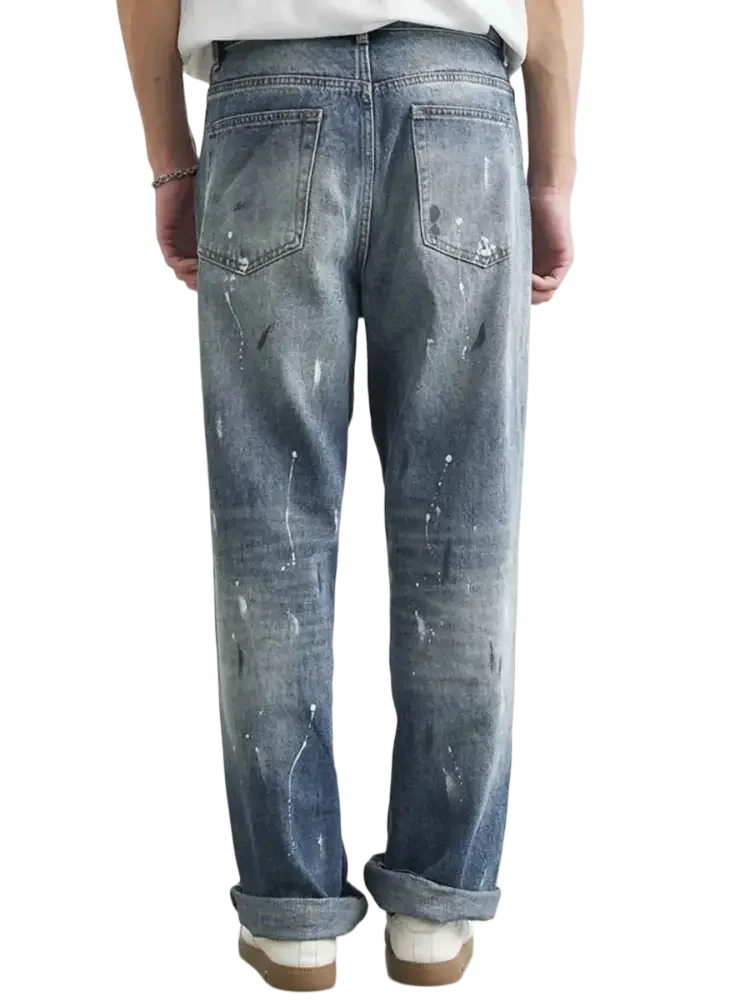 Distressed blue denim jeans with paint splatter relaxed fit for Men