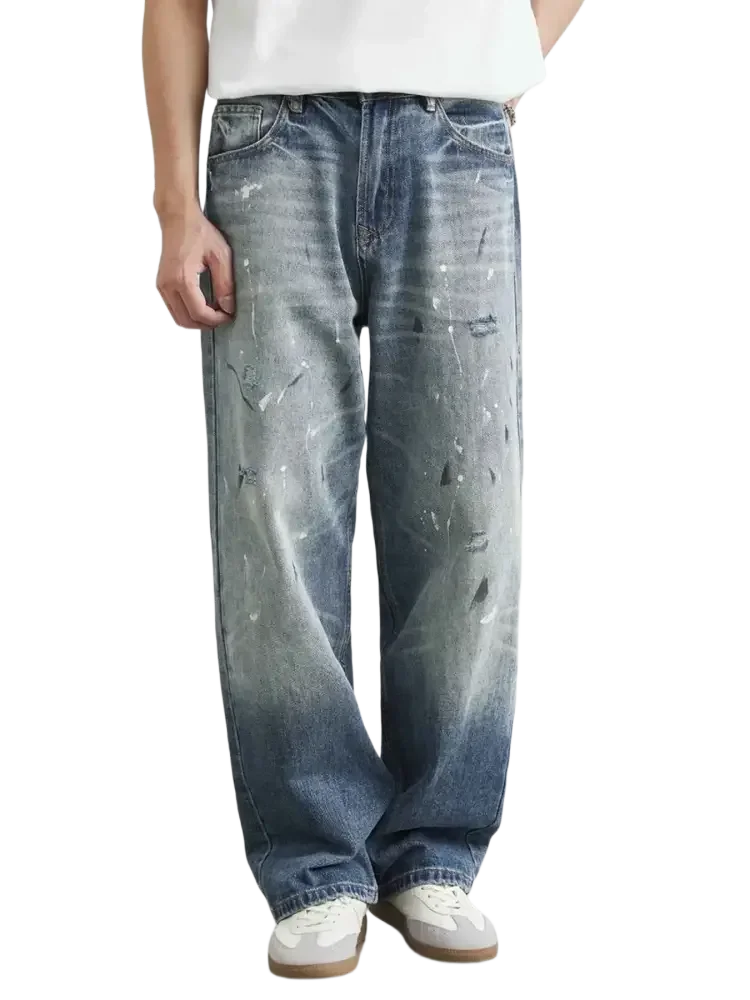 Men’s distressed paint splatter relaxed fit jeans with wide-leg design and faded wash