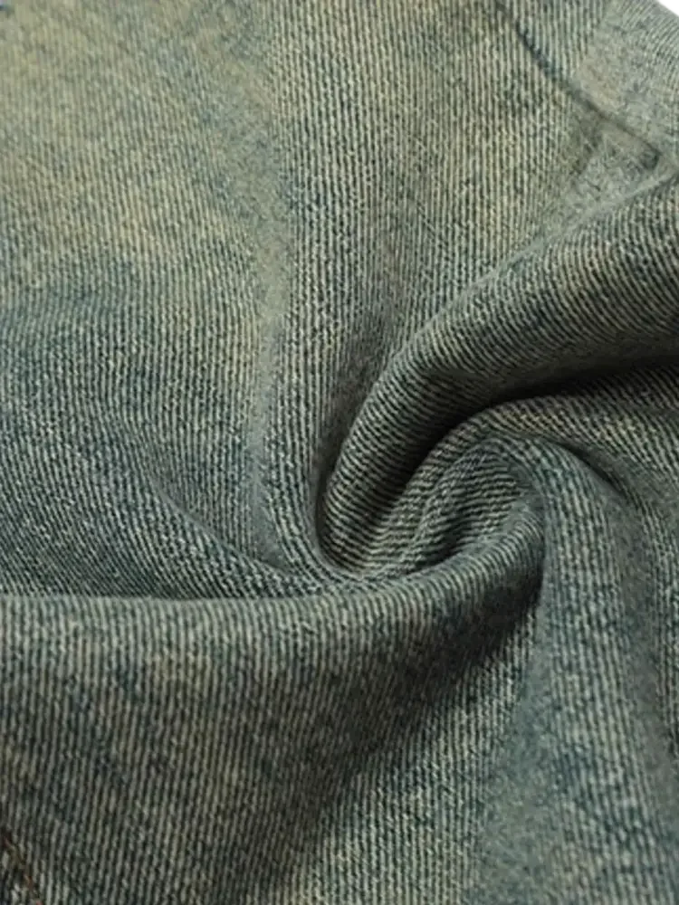 Faded light blue distressed straight leg jeans fabric with twill weave and soft texture