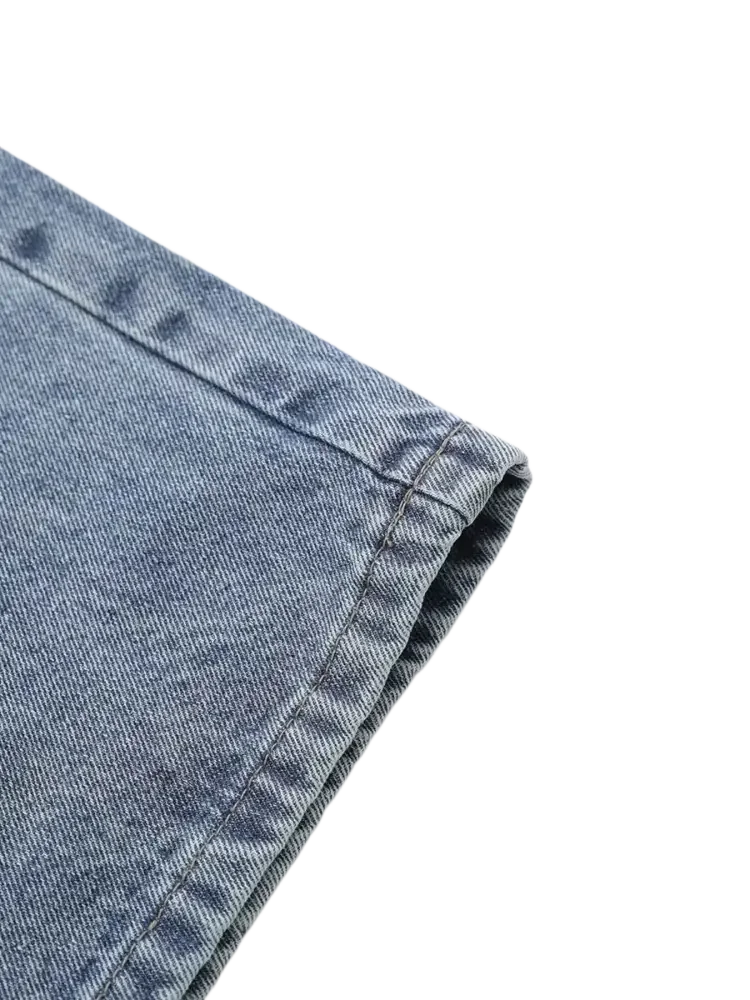 Light blue denim cuff with visible stitching on vintage patchwork wide leg jeans
