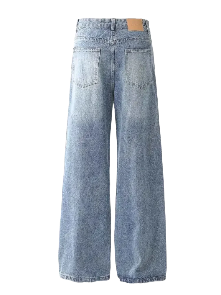 Light-wash blue vintage patchwork wide leg jeans with brown patch on back waistband