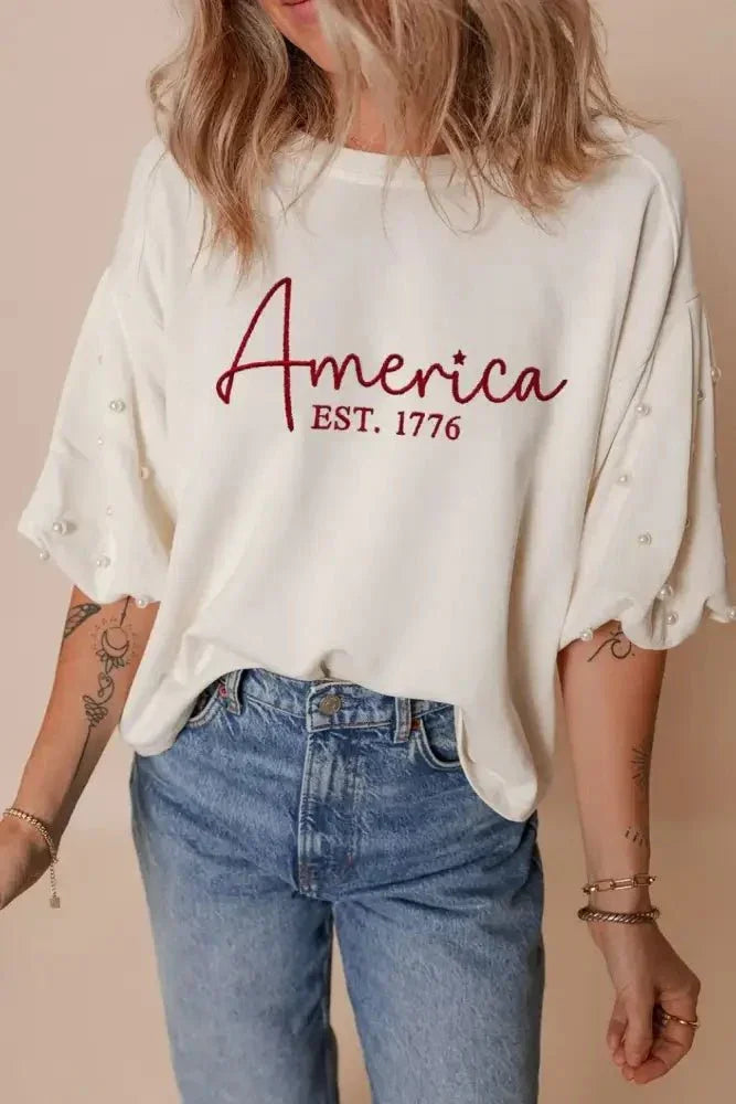 AMERICA EST 1776 Embroidered Pearl Beaded Sleeve T Shirt - Update AvenueT-ShirtsTrendsi100100804468917100100804468917484d6b12 - 00f0 - 4876 - ac26 - 6ab84d95a324 - Max - OriginWhite