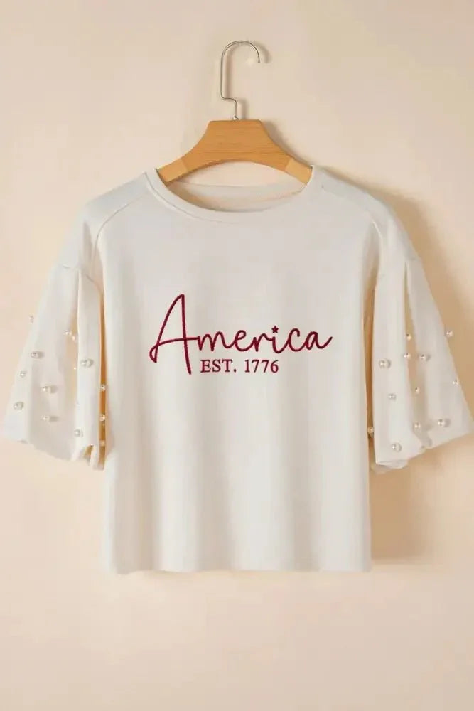 AMERICA EST 1776 Embroidered Pearl Beaded Sleeve T Shirt - Update AvenueT-ShirtsTrendsi100100804468917100100804468917ef0321a0 - 0421 - 4bc9 - 827f - cf36d6bdd0a0 - Max - OriginWhite