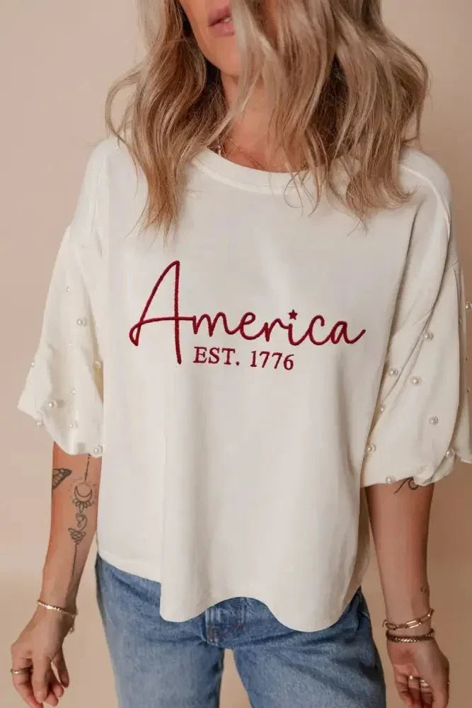 AMERICA EST 1776 Embroidered Pearl Beaded Sleeve T Shirt - Update AvenueT-ShirtsTrendsi100100804468917100100804468917794392e5 - e153 - 4fcd - bebe - e71014540dd3 - Max - OriginWhite
