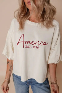 AMERICA EST 1776 Embroidered Pearl Beaded Sleeve T Shirt - Update AvenueT-ShirtsTrendsi100100804468917100100804468917794392e5 - e153 - 4fcd - bebe - e71014540dd3 - Max - OriginWhite