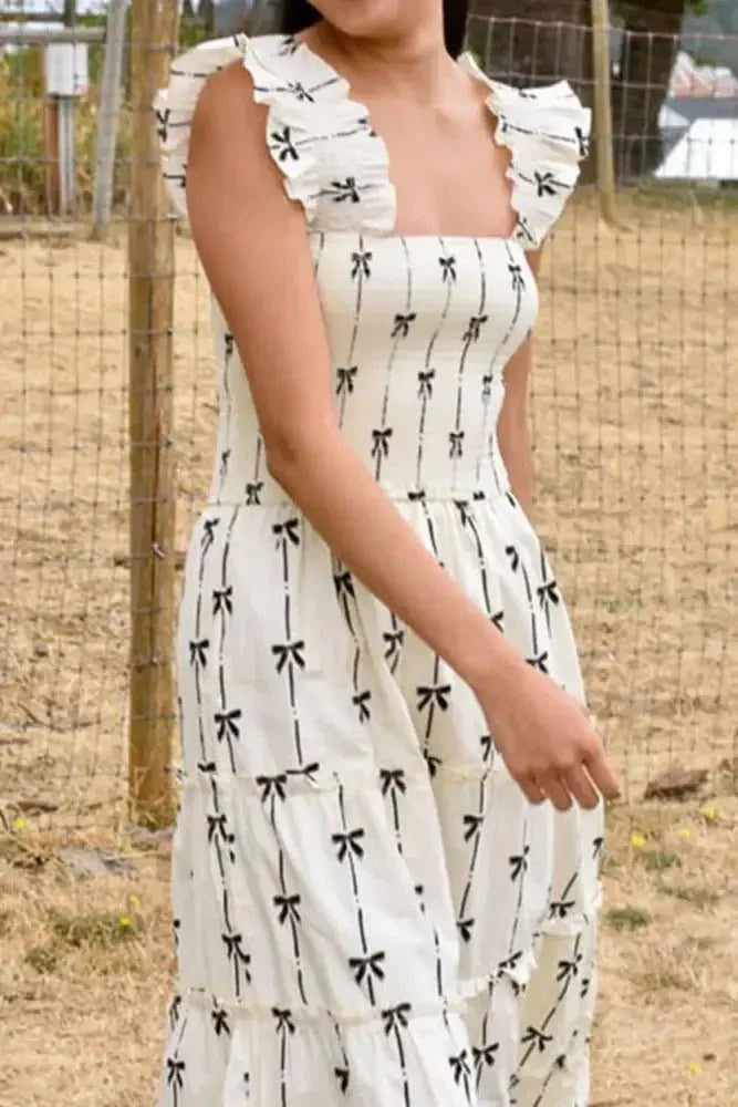 Bow Print Smocked Square Neck Ruffle Tiered Maxi Dress - Update AvenueFestival VibesTrendsi10010000201896010010000201896061b3a9dc - 34ee - 41a9 - 87e8 - 3737cda0ac4a - MaxWhite