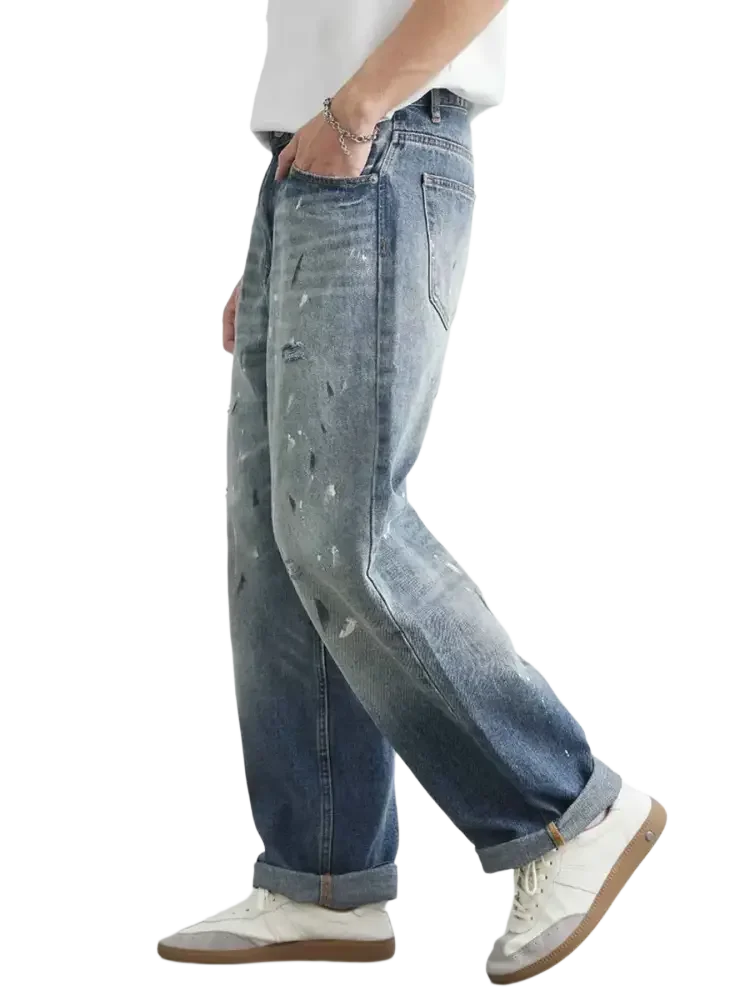Light blue distressed paint splatter relaxed fit jeans for men with stylish distressed details