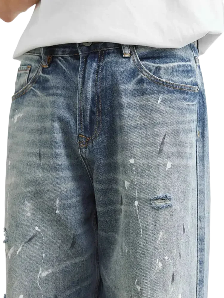 Light wash distressed paint splatter relaxed fit blue jeans for men