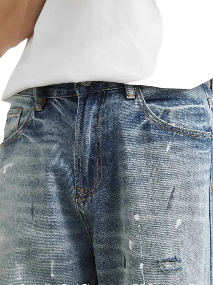 Distressed paint splatter men’s jeans with relaxed fit style and casual design
