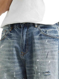 Distressed paint splatter men’s jeans with relaxed fit style and casual design