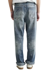 Distressed blue denim jeans with paint splatter relaxed fit for Men