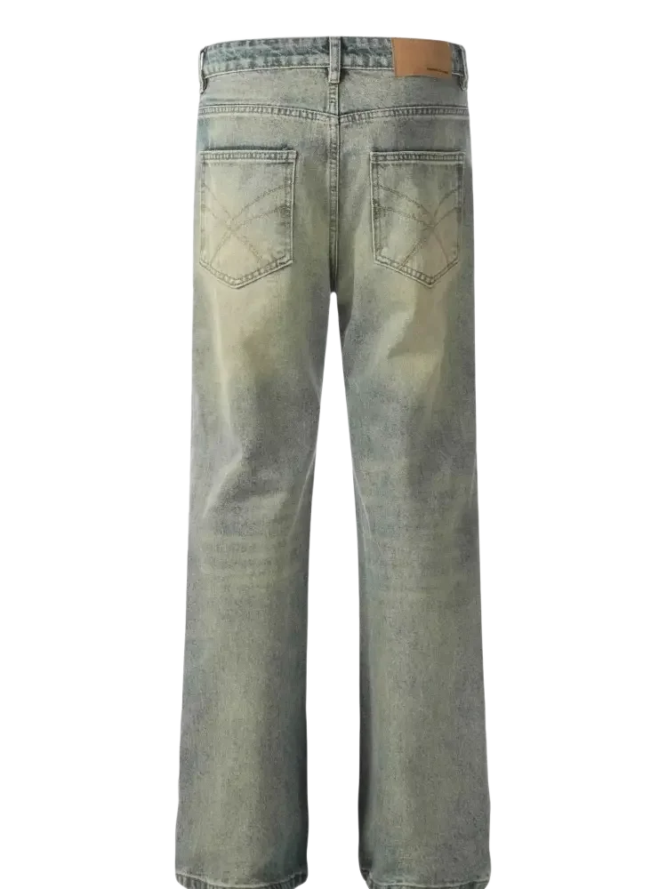 Washed-out blue distressed straight leg jeans with wide legs and leather patch at the back