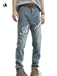 Men’s light wash blue slim fit jeans with lightning bolt graphics and Amiri embroidery