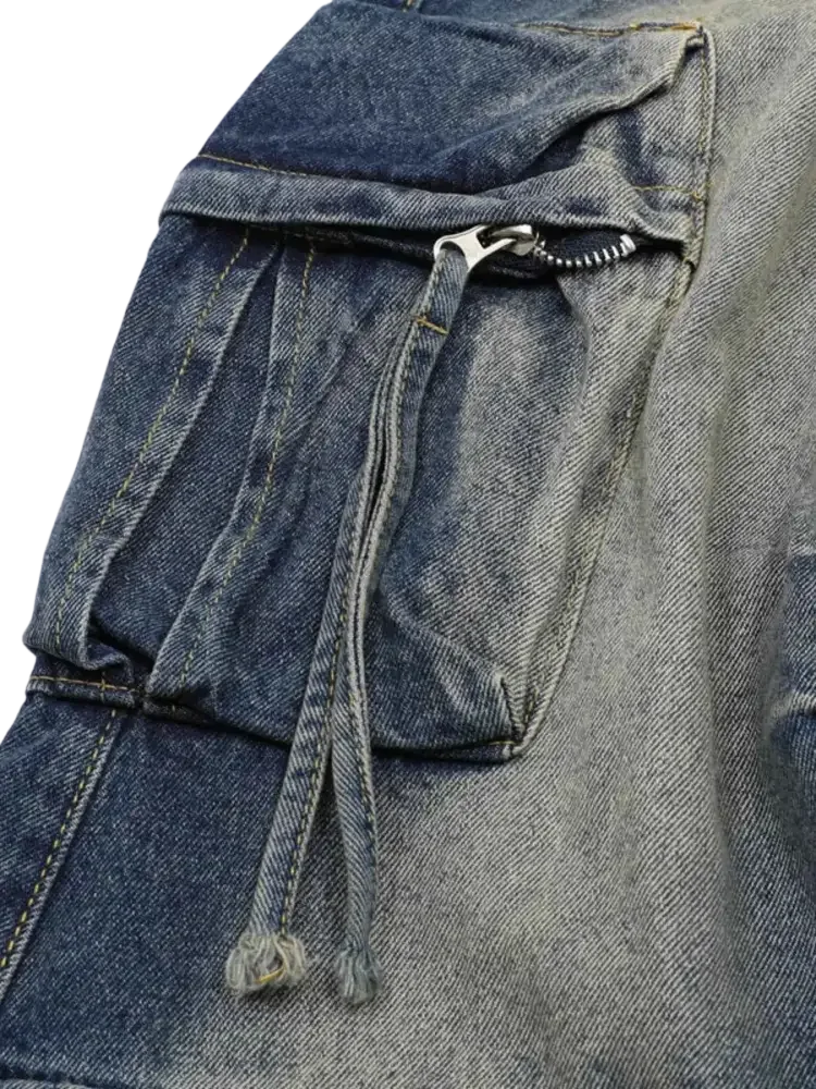 Distressed blue and grey denim cargo pants with zippered pockets and drawstring details in men’s full size washed cargo jeans plus size