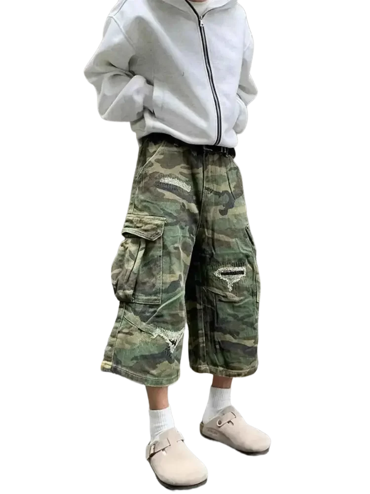 Plus size distressed camouflage cargo capris jeans worn with oversized gray hoodie and beige clogs