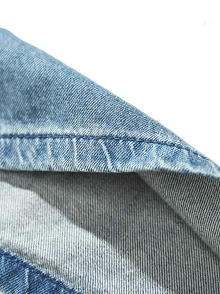 Light blue denim fabric with visible stitching on men’s plus size drawstring denim shorts