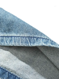 Light blue denim fabric with visible stitching on men’s plus size drawstring denim shorts
