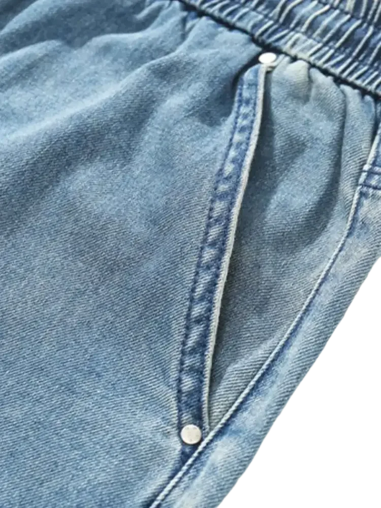 Plus size drawstring denim shorts with elastic waistband and side pockets featuring rivets