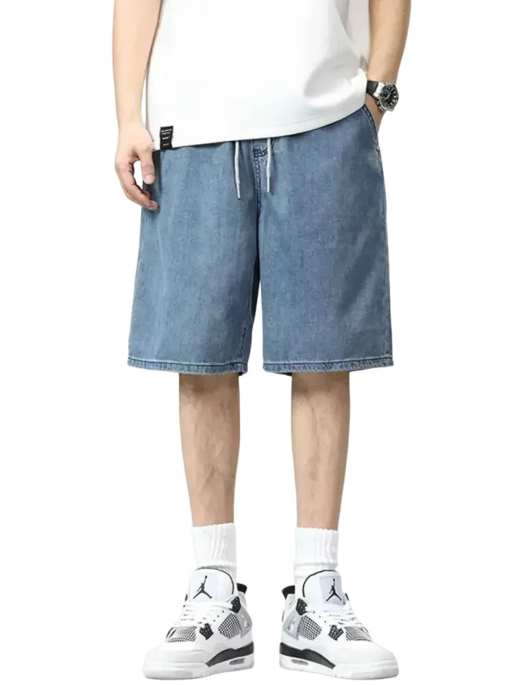 Plus size drawstring denim shorts worn with a white t-shirt and athletic shoes