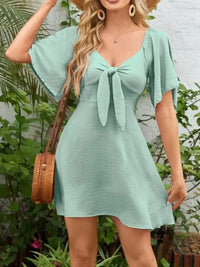 Smocked Back Knotted Flutter Sleeve Dress - Update AvenueEffortless Elegance: DressesTrendsi1001000098929681001000098929686ab4107b - 8b52 - 49a9 - b9b9 - 12771772494f - Max - OriginGum Leaf